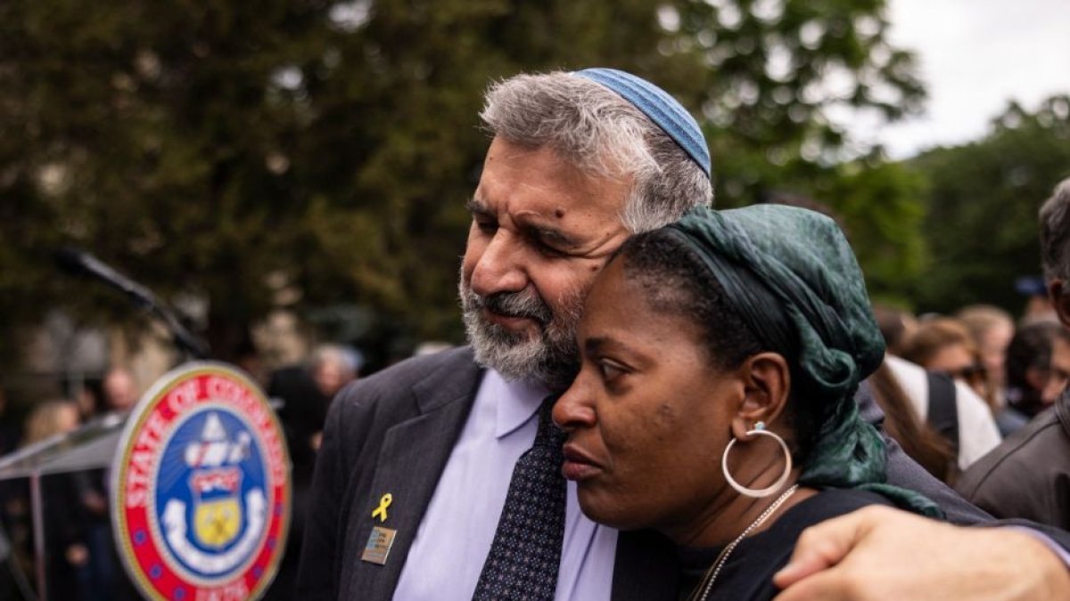 A rabbi comforting people at the scene of the attack on Jews in Boulder.