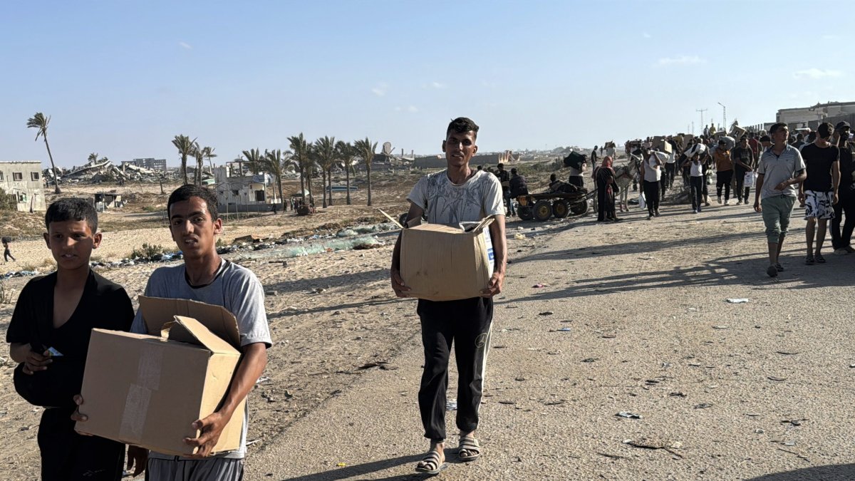 Palestinians carry humanitarian aid in Gaza