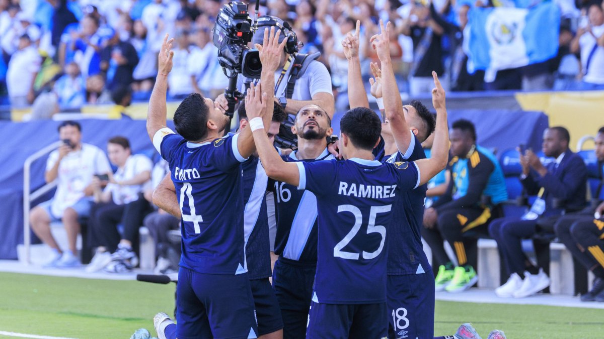Guatemala's players celebrate Santis' goal.