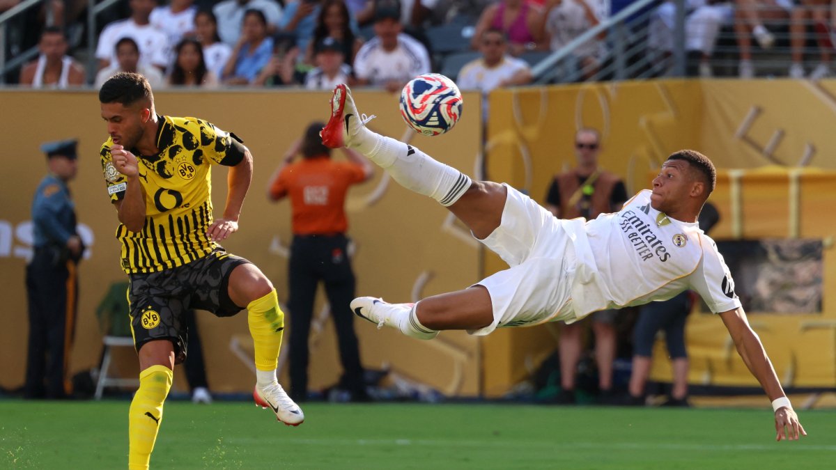 Mbappe scoring a goal against Borussia Dortmund.