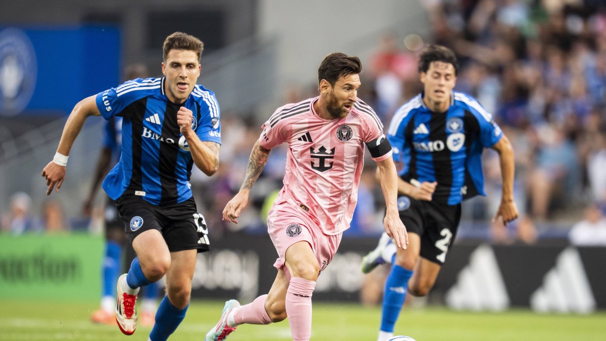 Leo Messi advances with the ball in front of CF Montreal