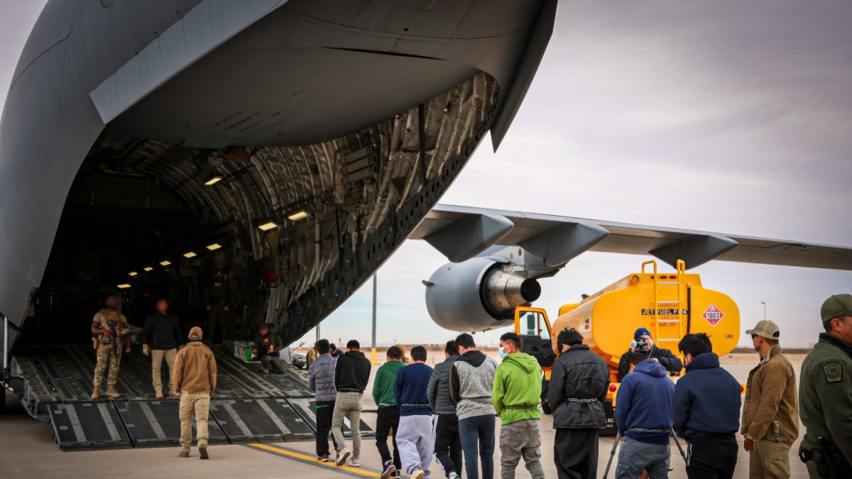 A group of illegal immigrants board a plane to be deported