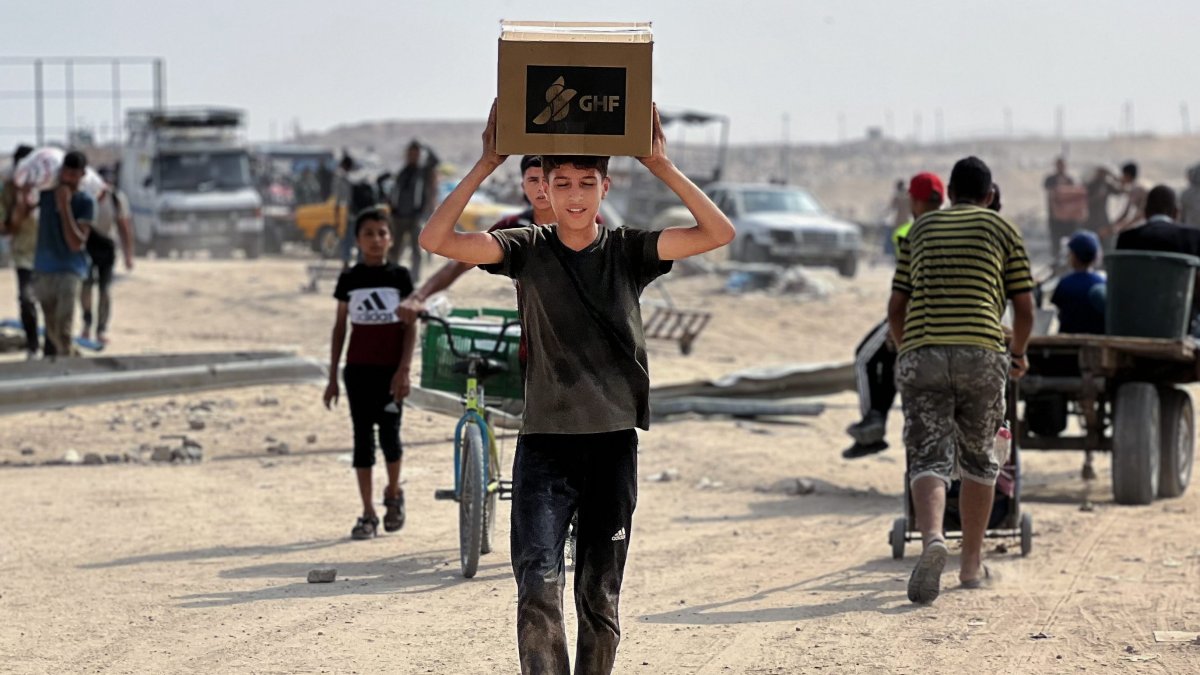 Palestinians receive humanitarian aid in Gaza.