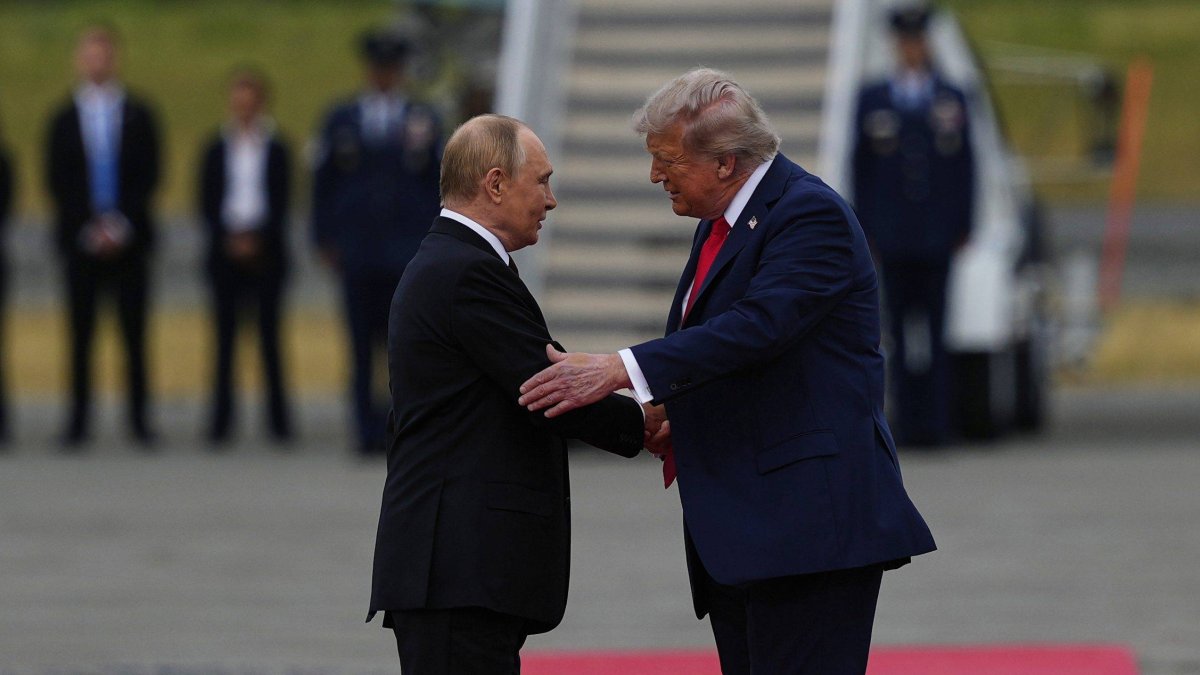 President Donald Trump greets Russian President Vladimir Putin on the tarmac.