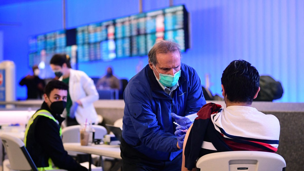 The Covid-19 vaccine is administered in the international arrivals section of Los Angeles International Airport