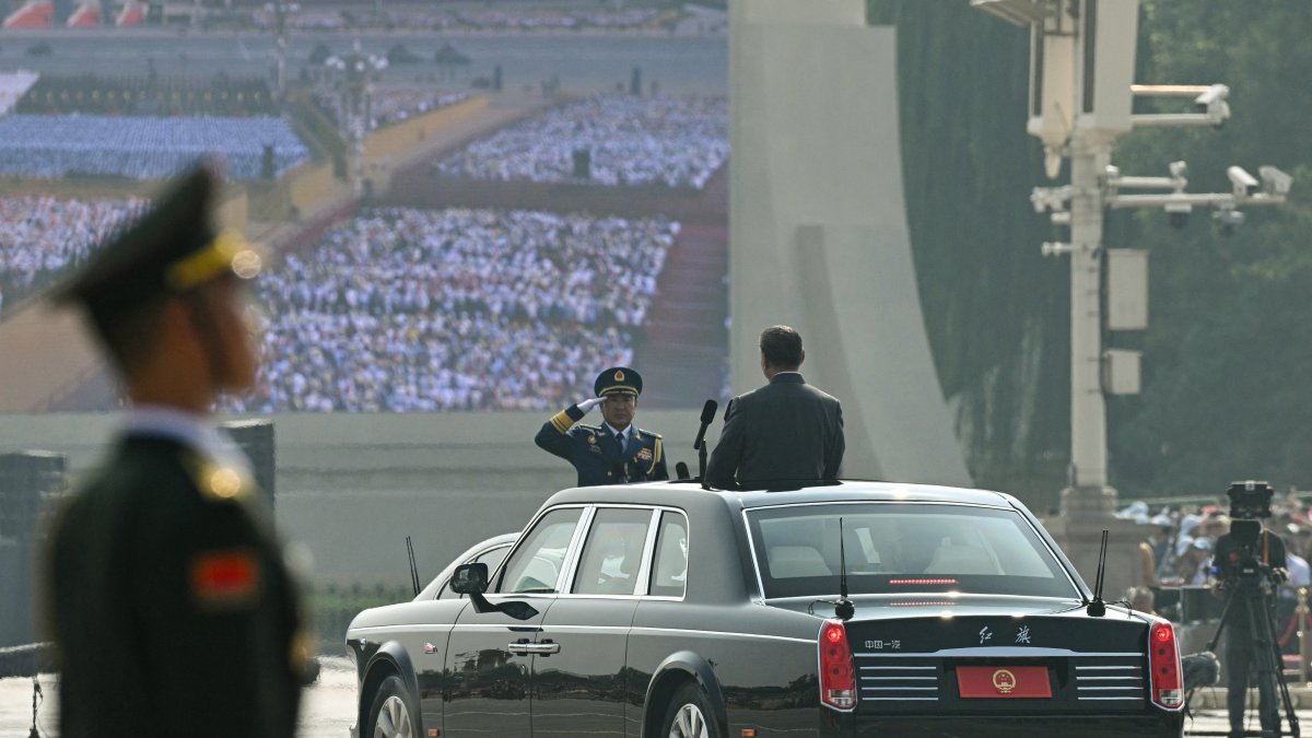 Xi Jinping receives the military salute before beginning his inspection of troops.