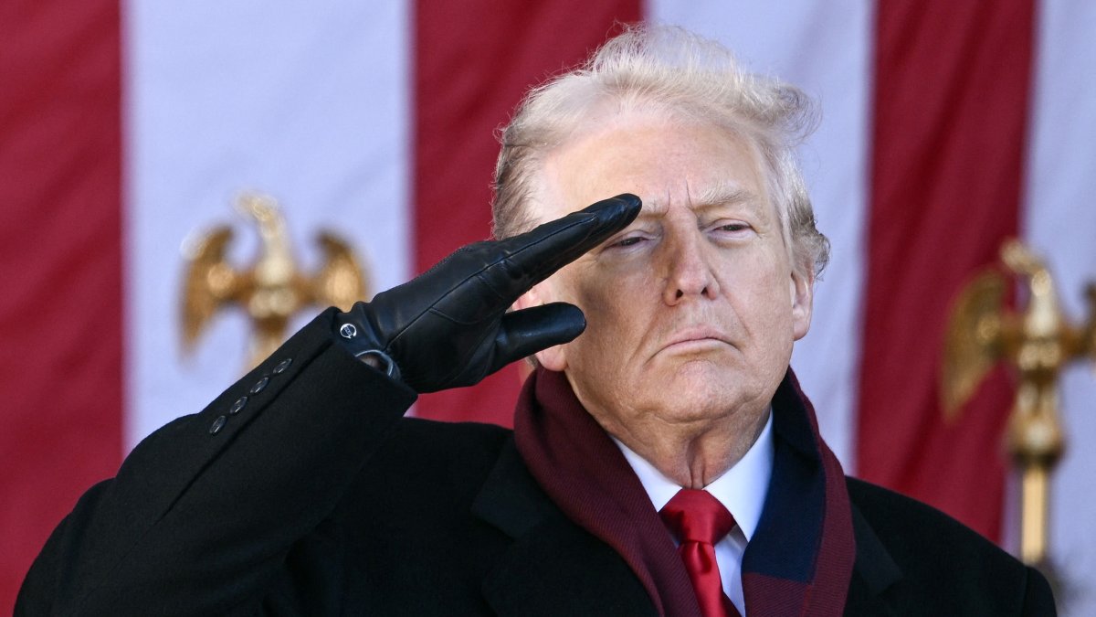 US President Donald Trump salutes at the conclusion of a Veterans Day ceremony