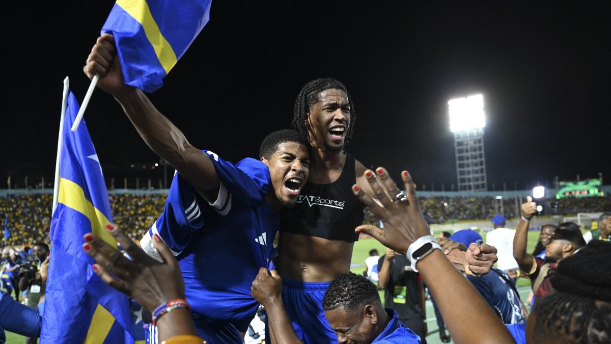 Curazao players celebrate with fans after qualifying for the World Cup.