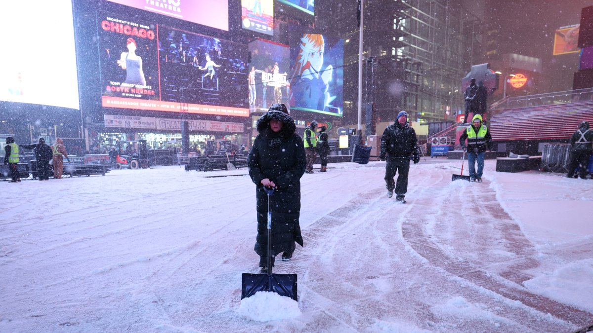 Workers clear snow from the streets of New York.