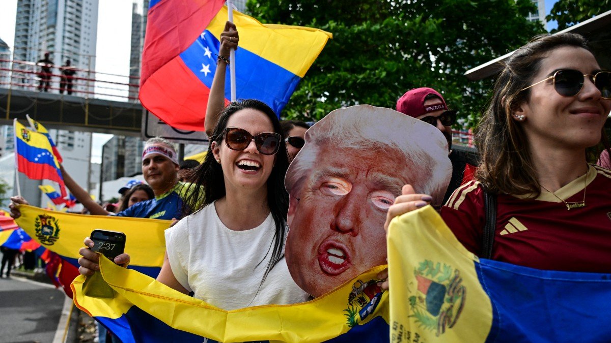 Venezuelans in Panama celebrate with flags and a Trump mask
