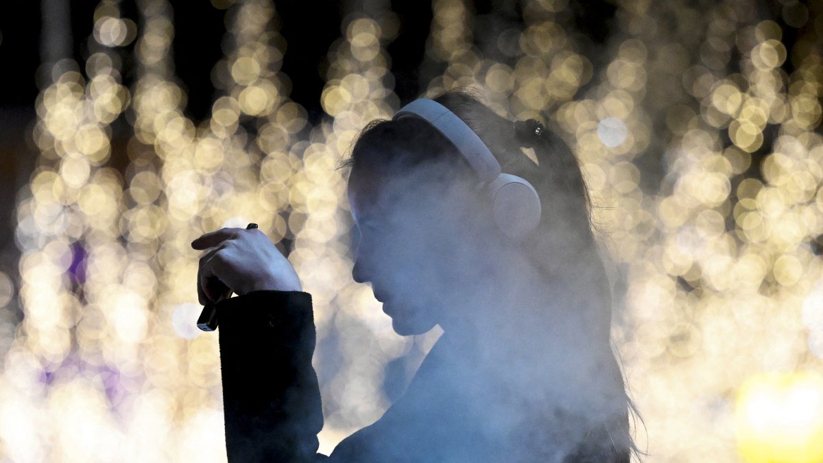 A young girl smokes an electronic cigarette