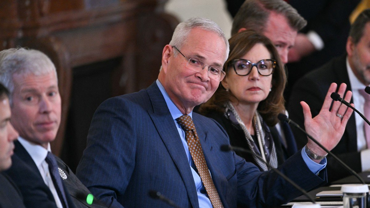 Darren Woods (C), CEO of ExxonMobil, attends a meeting with Donald Trump