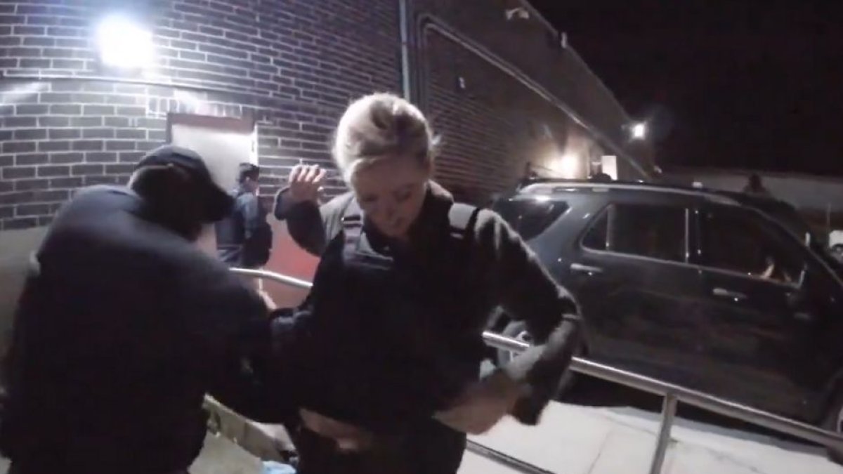 CNN reporter Pamela Brown is fitted with a bulletproof vest by an ICE agent.