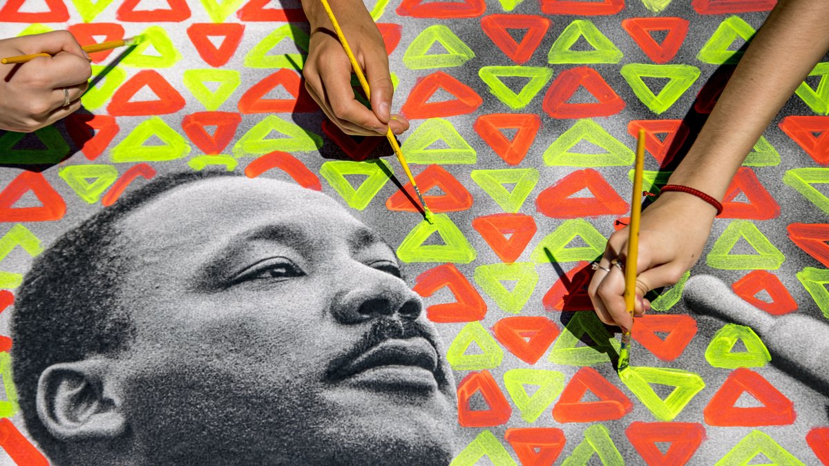 Students paint an image of Martin Luther King Jr.