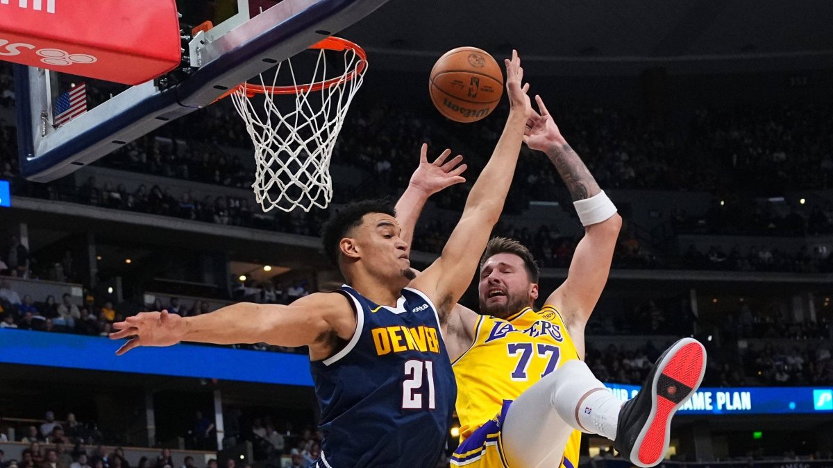 Doncic tries to drive to the basket against Spencer Jones (21).