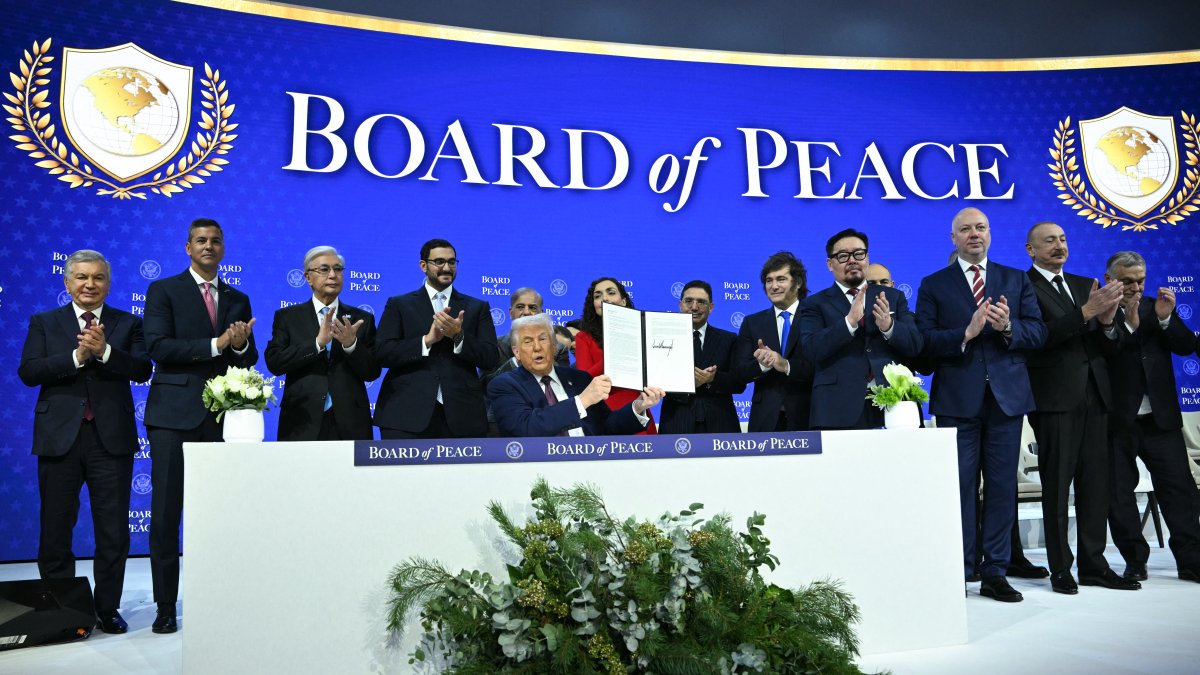 Trump displays the founding charter of the Peace Board.