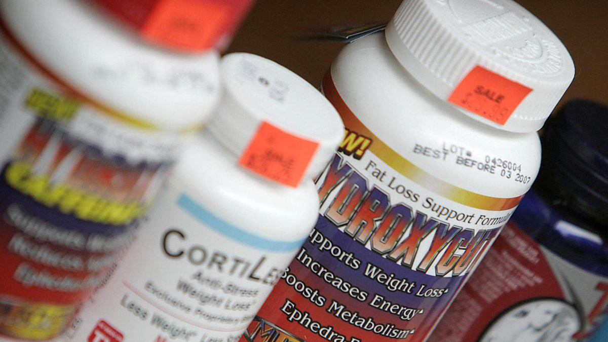 Vitamins and supplements are displayed in a store window.