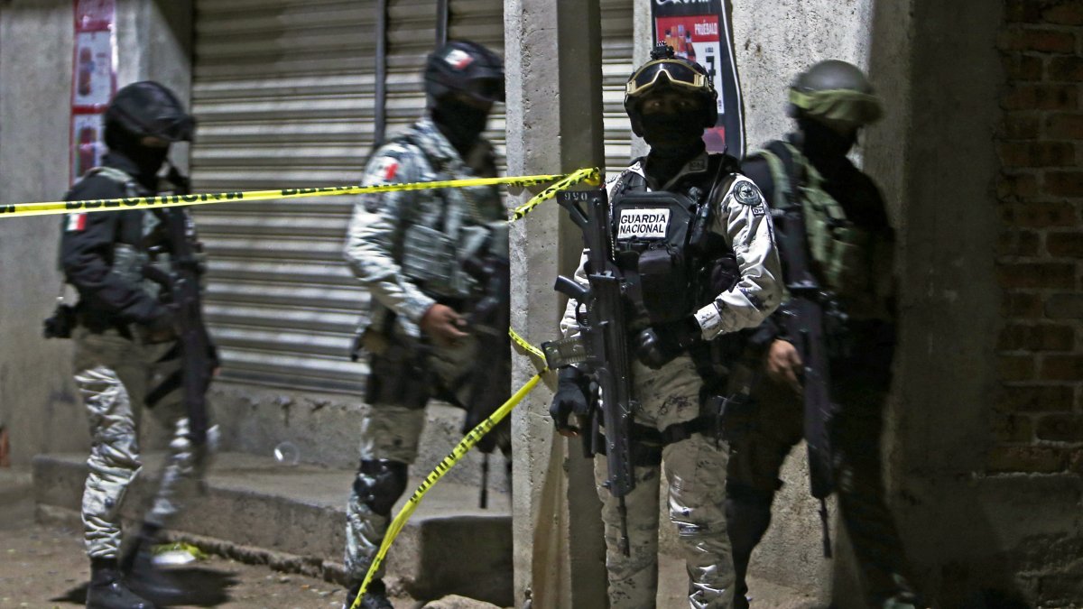National Guard members at the scene of a mass shooting that left 11 dead in Mexico.