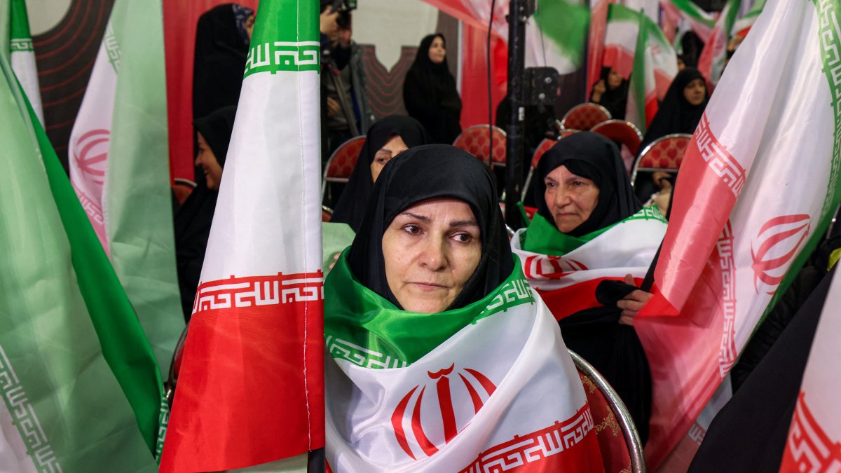 Women with Iranian flags mourn for the victims of terrorism killed in protests in Iran.
