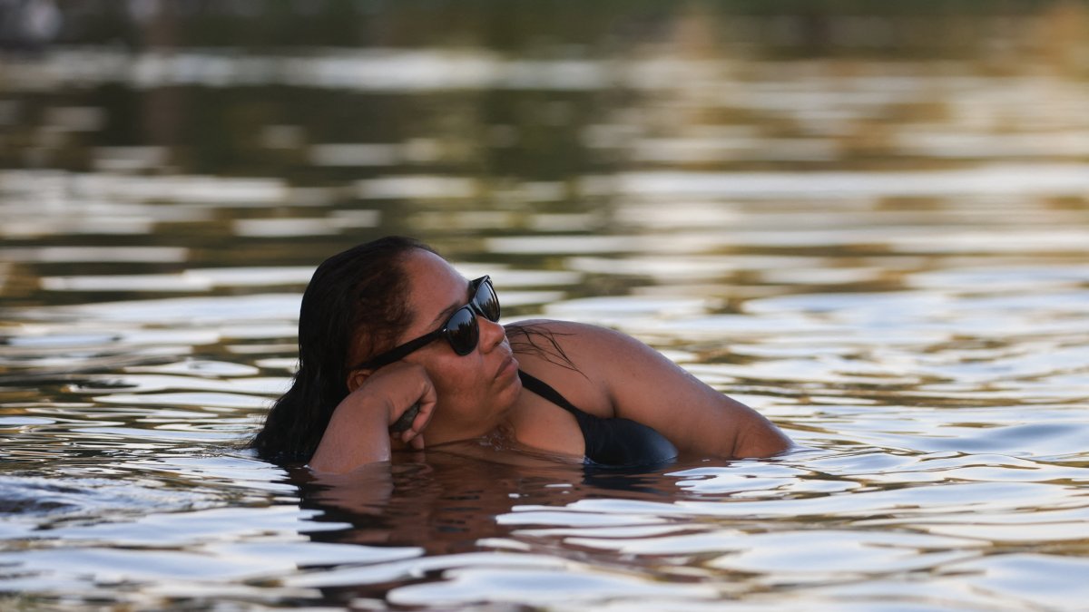 A woman cools off in a lake (File).