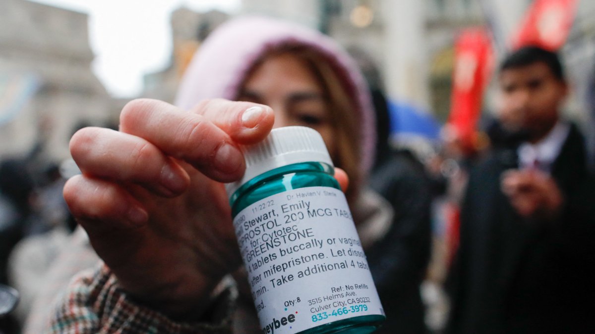 A pro-abortion activist with abortion pills in the middle of a protest (File).