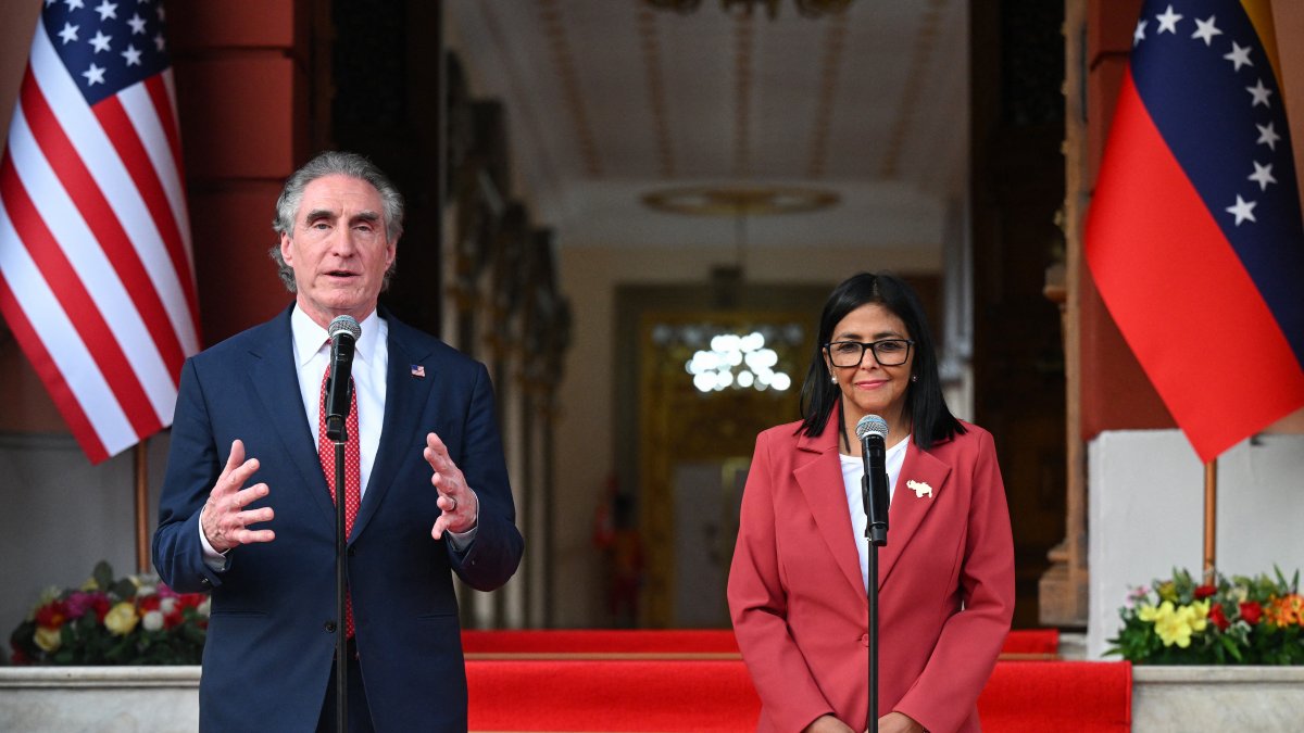 Doug Burgum and Delcy Rodríguez in Caracas.