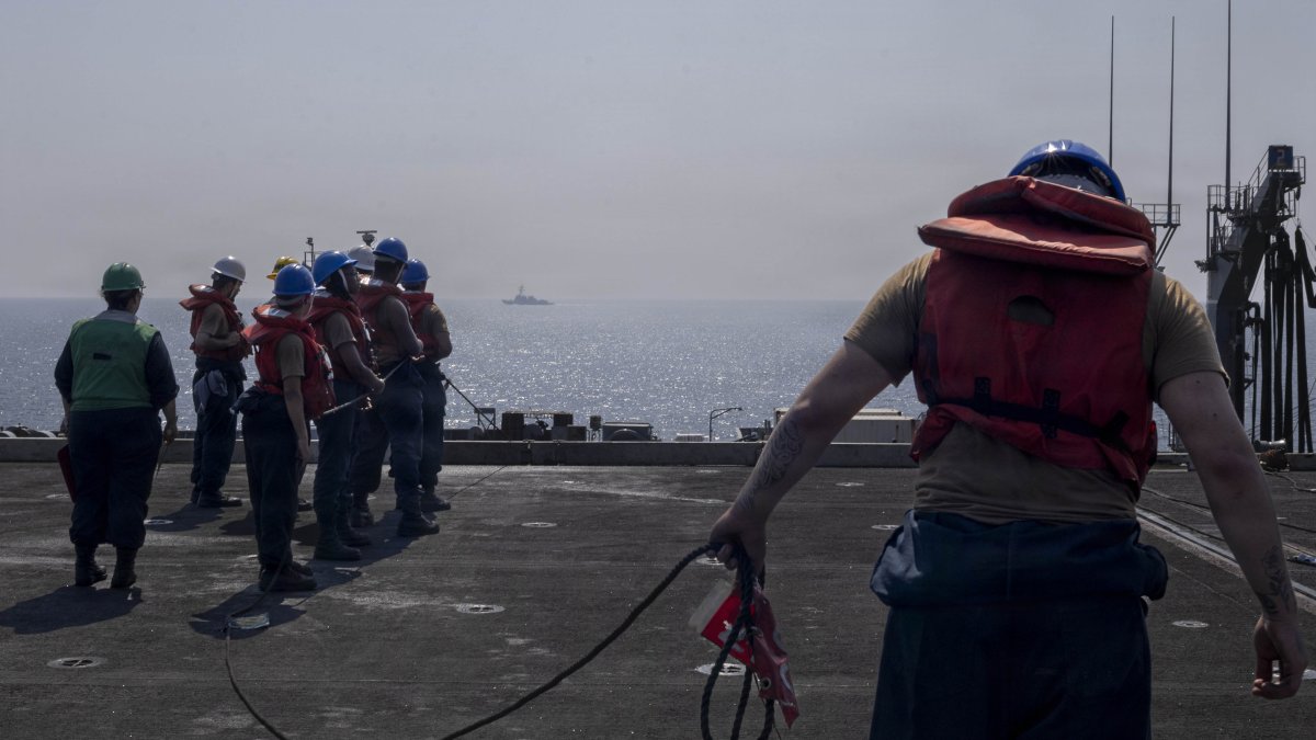 Sailors from the USS Abraham Linclon prepare for a resupplying operation.