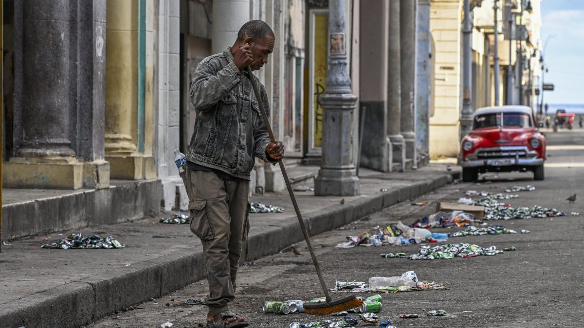 A man tries to clean up the streets of Havana.