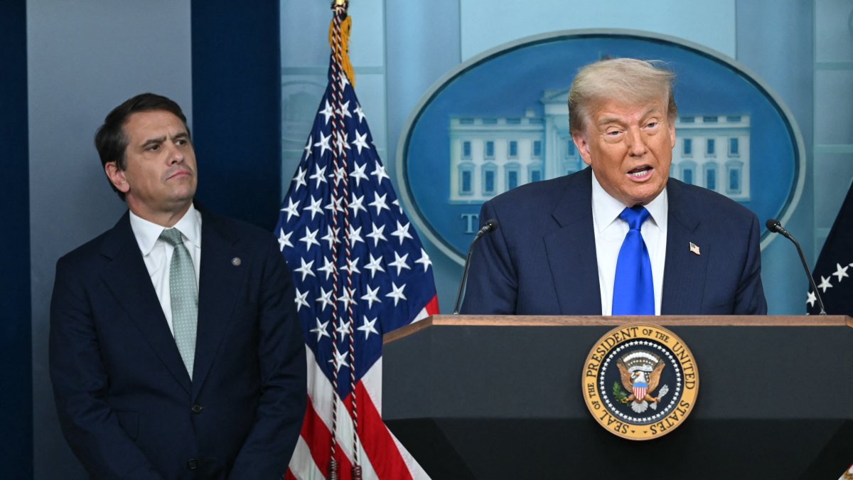 Donald Trump next to Todd Blanche/ Andrew Caballero- Reynolds.