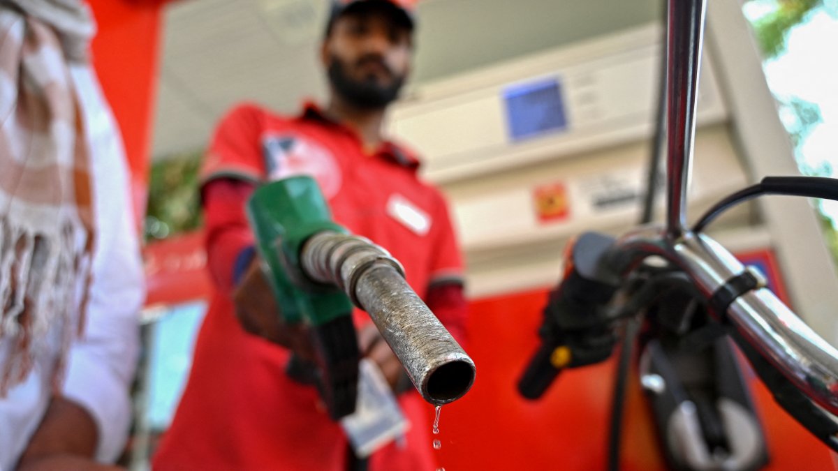 An employee dispenses fuel at a gas station (File).