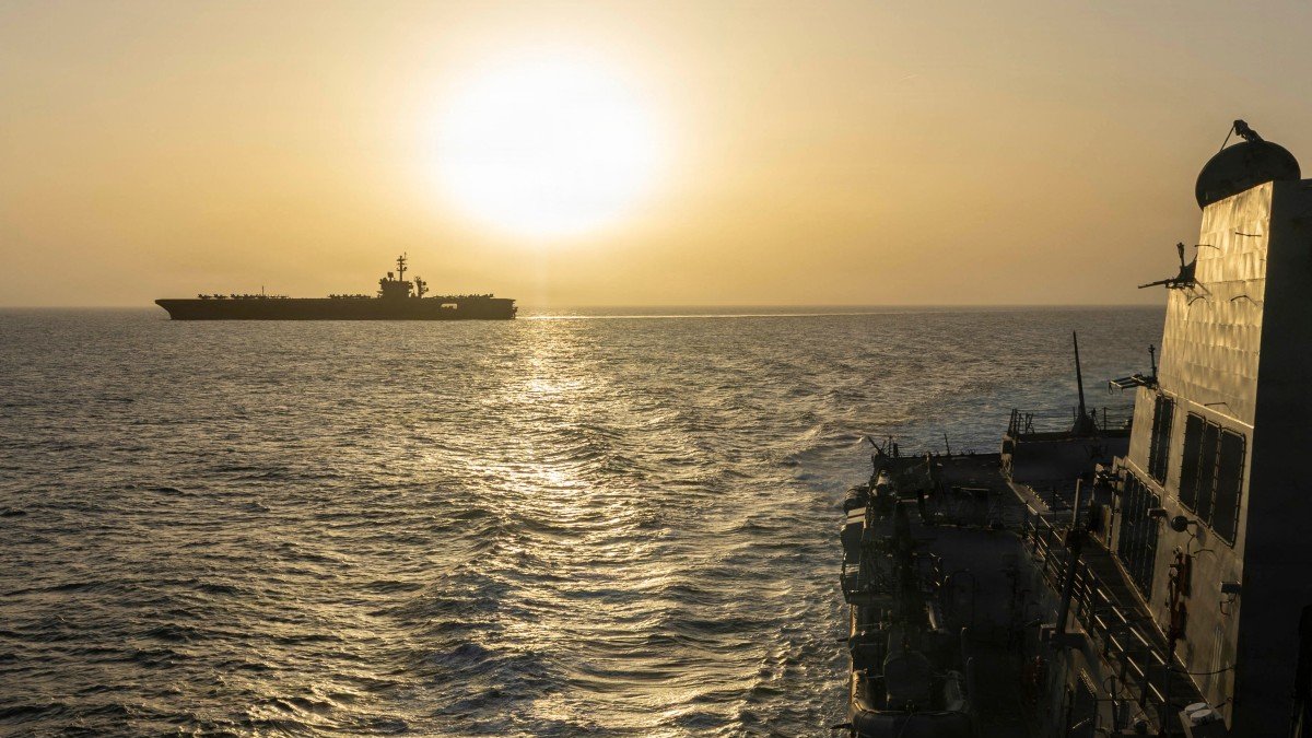 The USS Abraham Lincoln (left) conducts blockade operations in the Arabian Sea