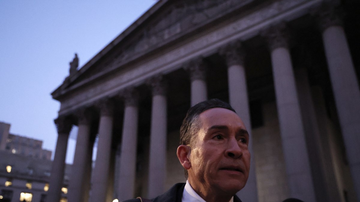 Juan Orlando Hernández's lawyer, Raymond Colon, speaks to the media during the trial