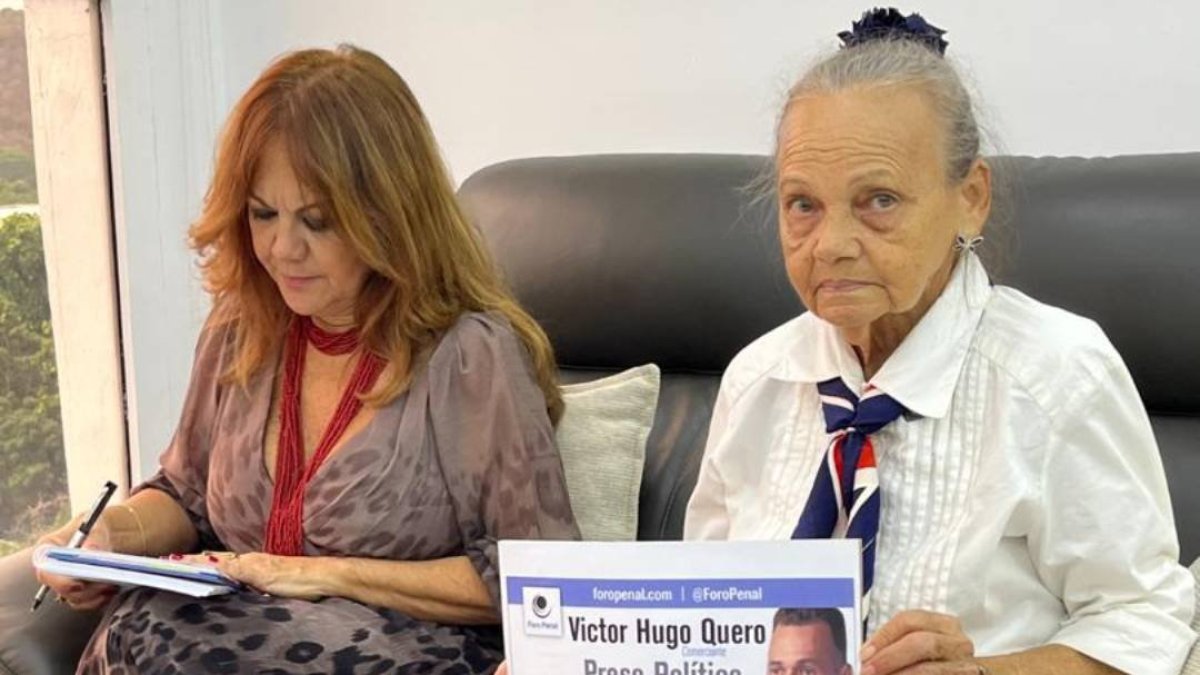 Carmen Navas with a sign asking for her son, Victor Quero.