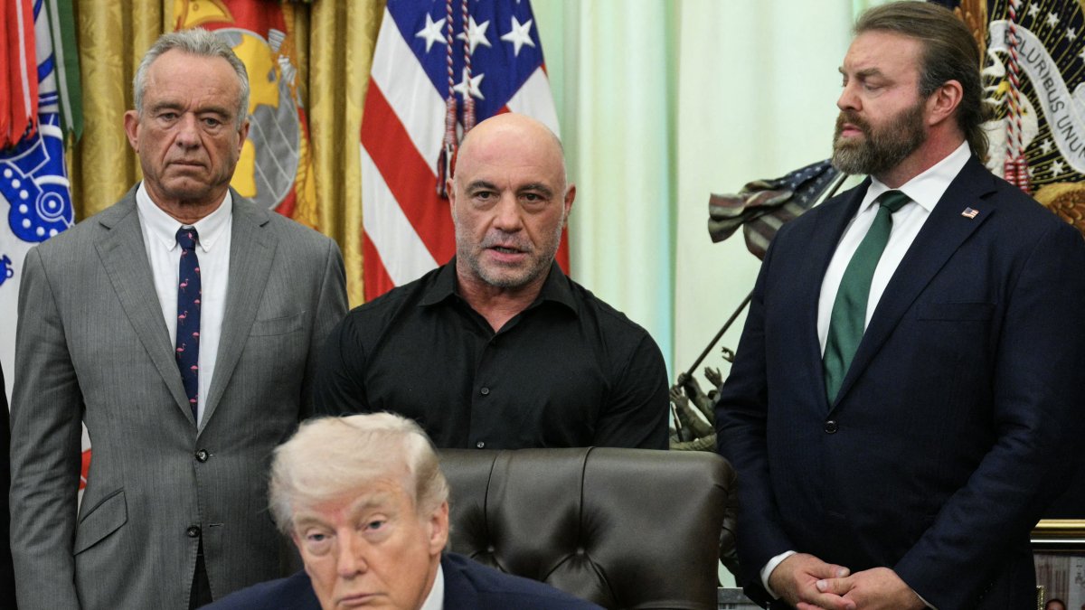 Joe Rogan, standing with President Donald Trump and Health Secretary Robert F. Kennedy Jr.