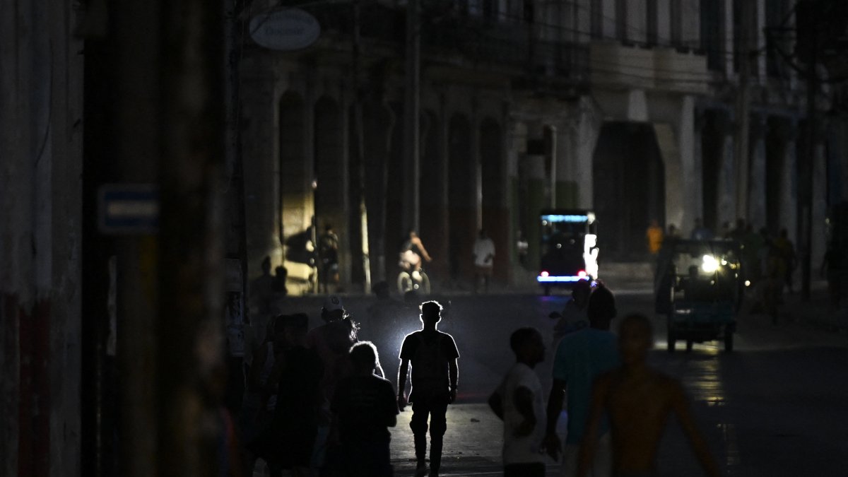 People walking during a blackout in Havana (File).