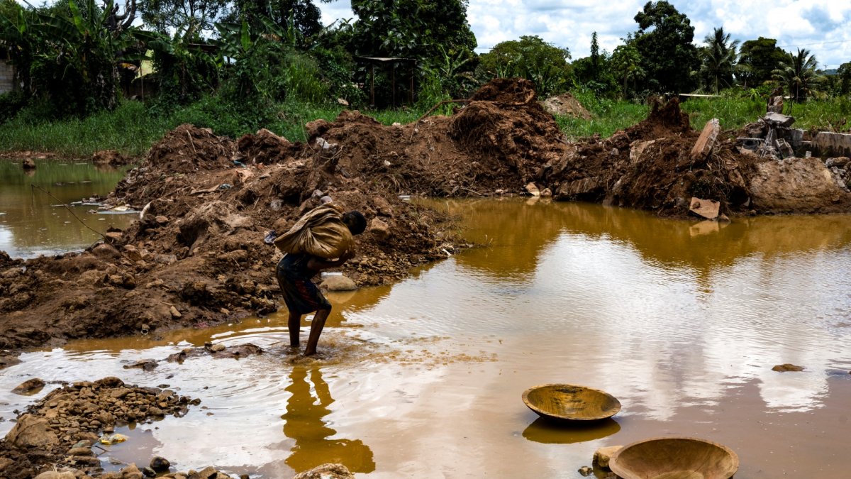 A young miner works in an open-pit mine searching for gold to sell in El Callao, Bolívar