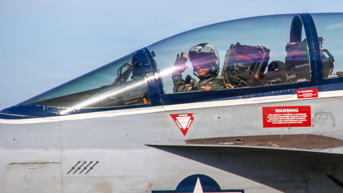 A pilot salutes from his fighter