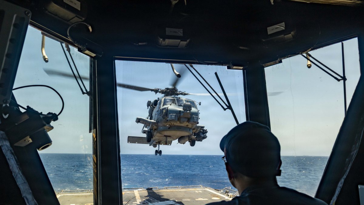A helicopter takes off from the USS Rafael Peralta (DDG 115) in Hormuz.