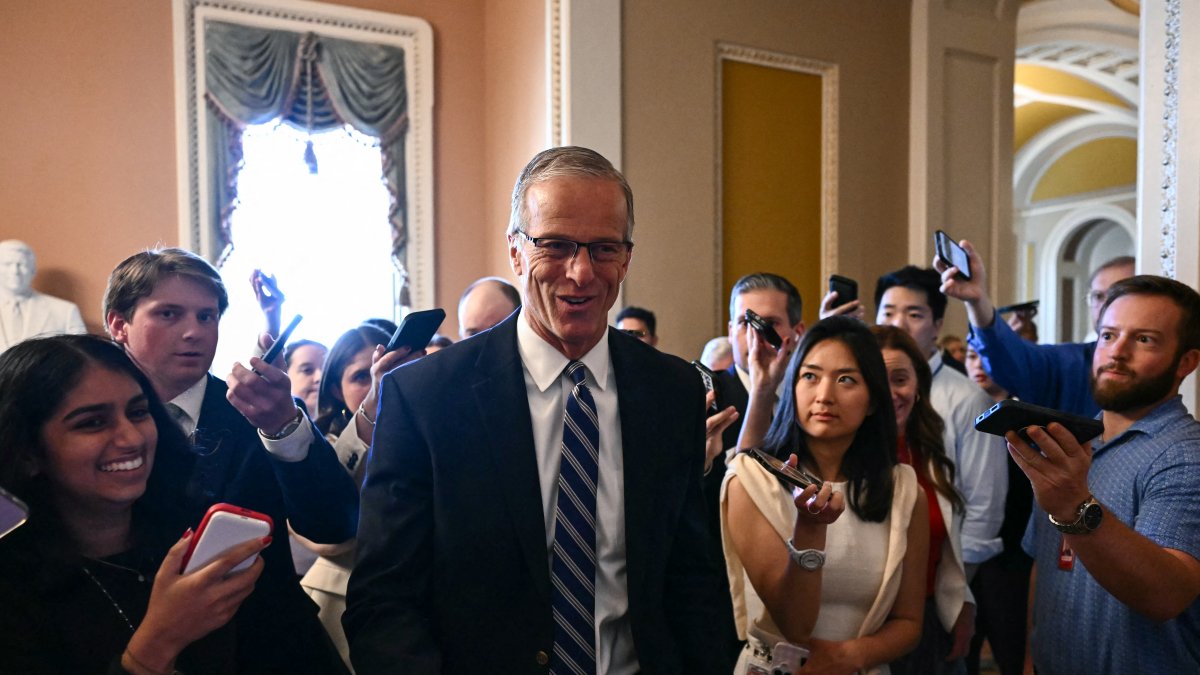 John Thune, surrounded by reporters on Capitol Hill.