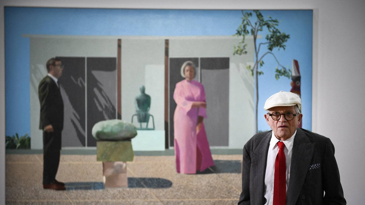 David Hockney posa frente a su cuadro