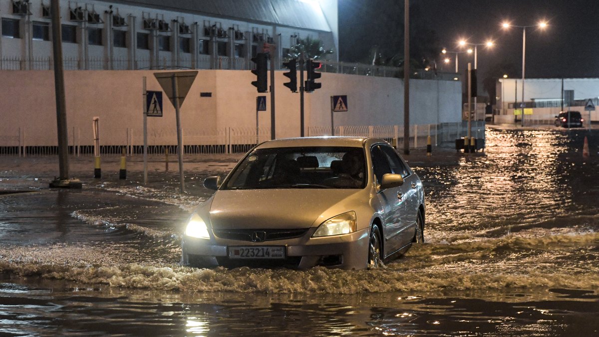 A vehicle drives down a flooded street (File photo)
