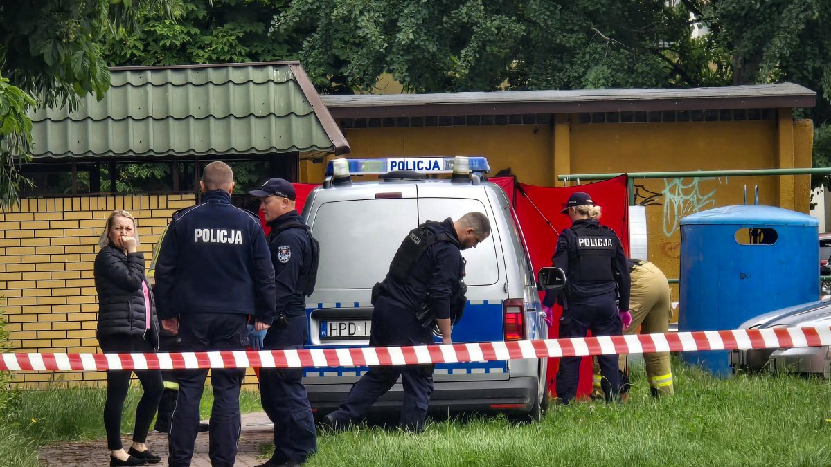Police working at a crime scene covered by a tarp in Biała Podlaska