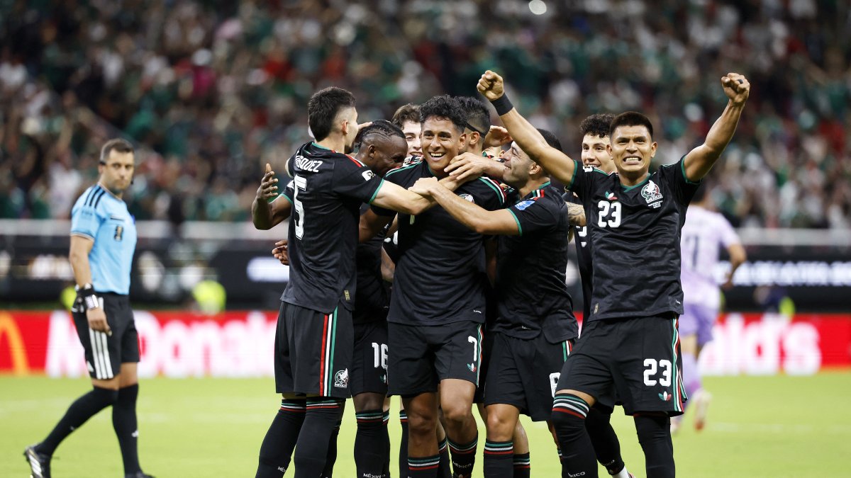 Luis Romo celebrates his goal with the rest of the Mexican national team.
