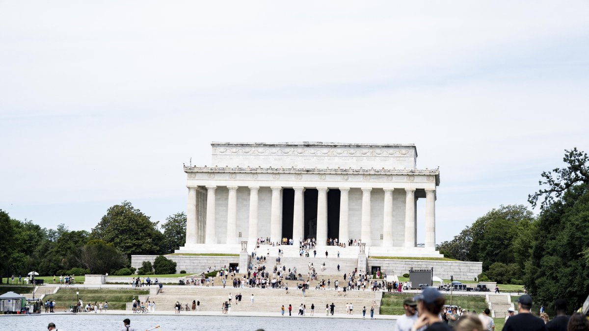 Workers remove algae from the reflecting pool at the Lincoln Memorial on Friday, June 19.