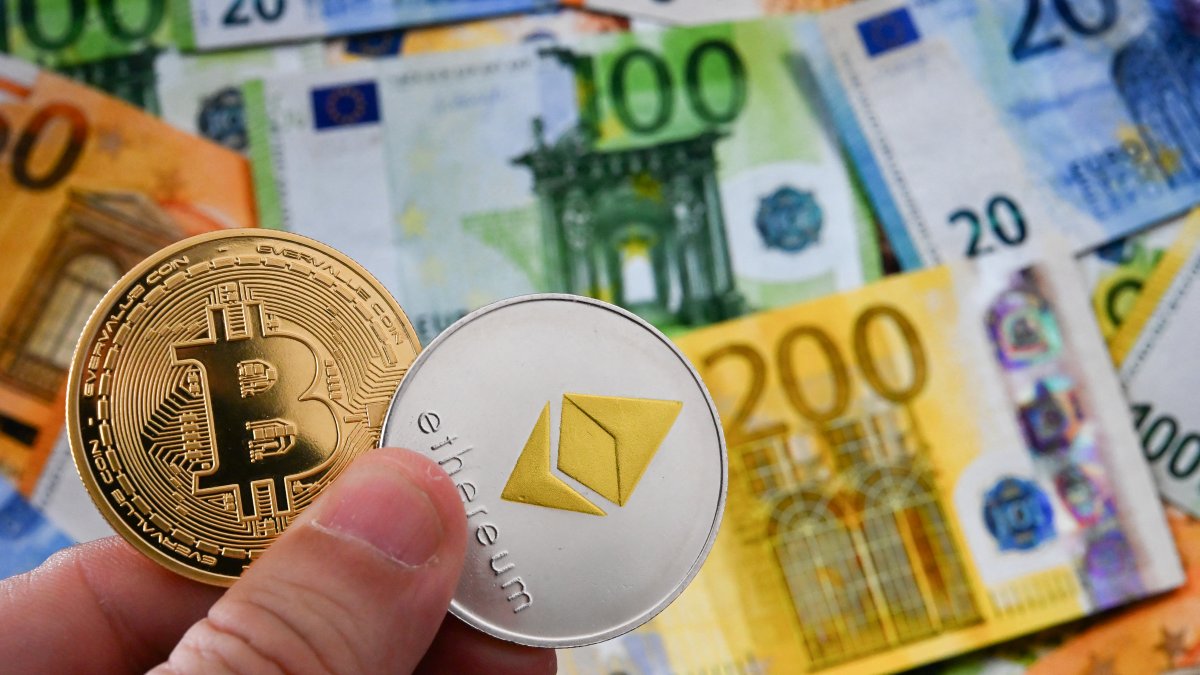 Illustration of Bitcoin and Ethereum coins next to various euro banknotes (File photo)