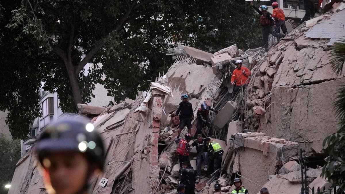Rescue teams evacuate an injured person from a collapsed building following an earthquake in Caracas