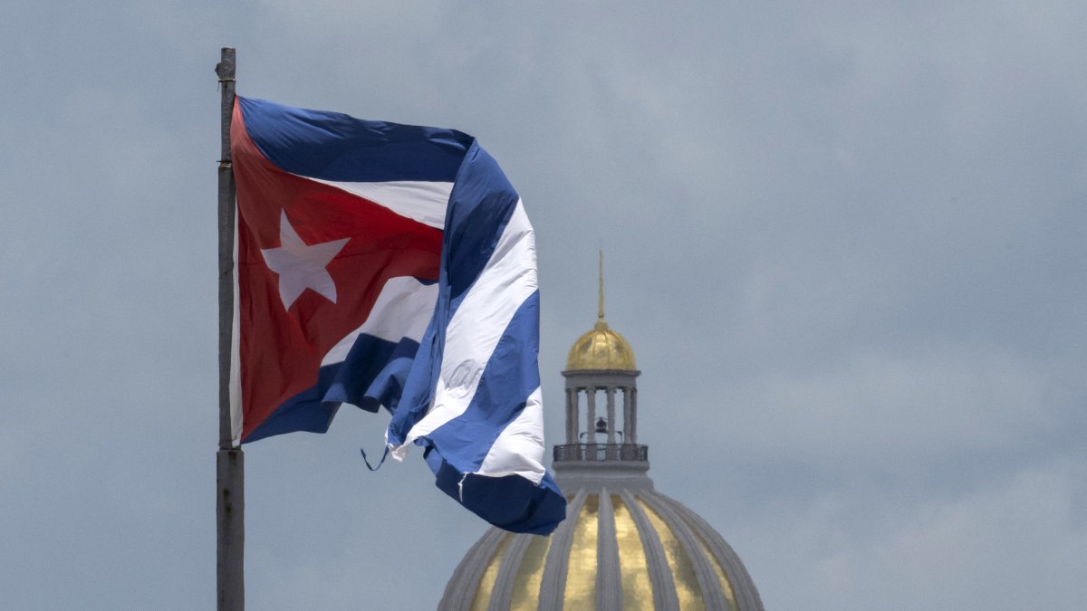 The Cuban flag flies over Havana’s Malecón, with the Capitol in the background (Files)