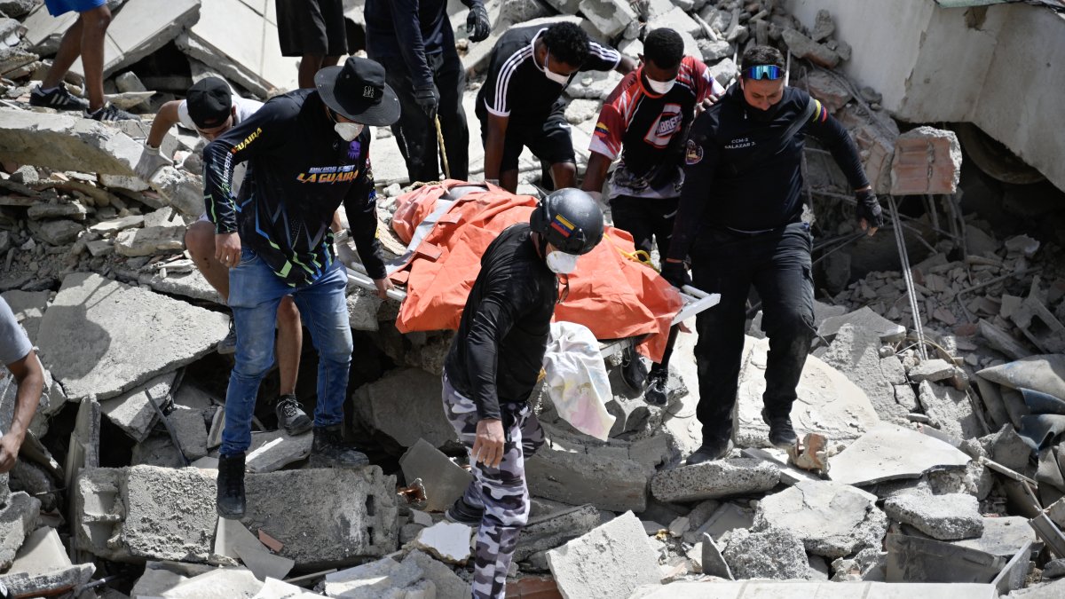 Volunteers recover bodies trapped in the rubble following the earthquake in Venezuela