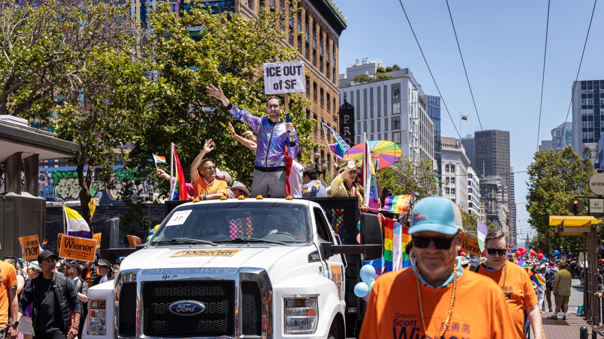 Scott Wiener (holding a sign against ICE) participates in the 2025 Pride march in San Francisco
