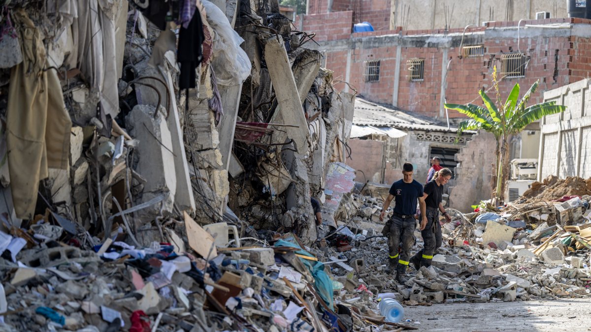 French rescue workers survey a damaged building in Catia La Mar, La Guaira state, Venezuela, on June 29, 2026.